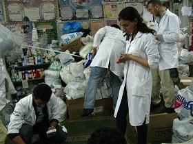 
Medical students sort through bags of donated medications to stock the pharmacy.
