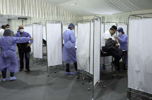 A man receives a dose of the Pfizer/BioNTech vaccine against COVID-19 at Saint George Hospital University Medical Center, in Beirut, Lebanon on February 14, 2021.