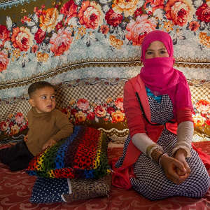 Young adolescent Syrian girl and her brother living in an informal tented settlement in Jordan.