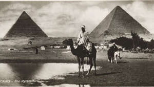 An old postcard with a picture of the Pyramids of Giza.