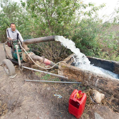 Farmer pumping ground water for irrigation in Cairo, Egypt