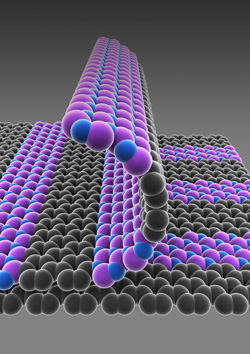 パターニング再成長法で作製した原子1個分の厚さの薄膜。導電性グラフェン（灰色）と窒化ホウ素（紫と青色）との間には明確な境界がある。